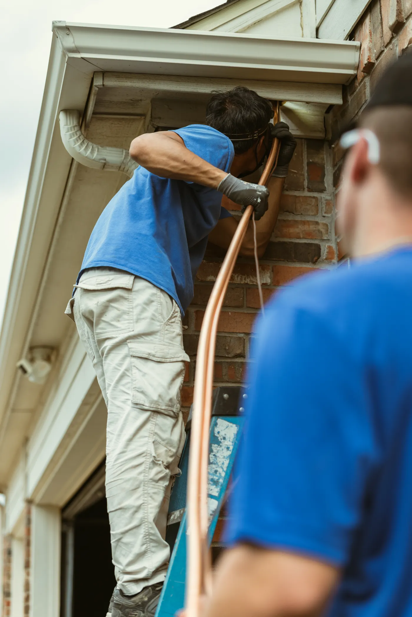 A home-service crew running new copper line on a jobsite